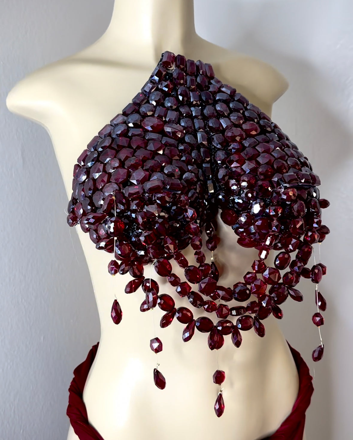 Deep ruby red jeweled breast plate .