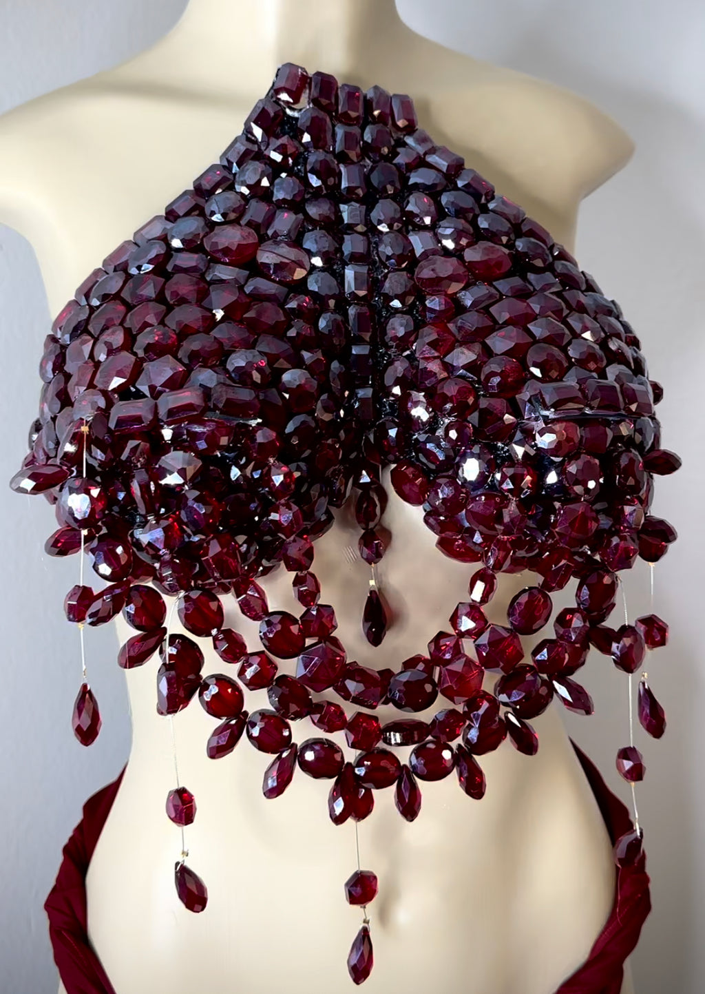 Deep ruby red jeweled breast plate .