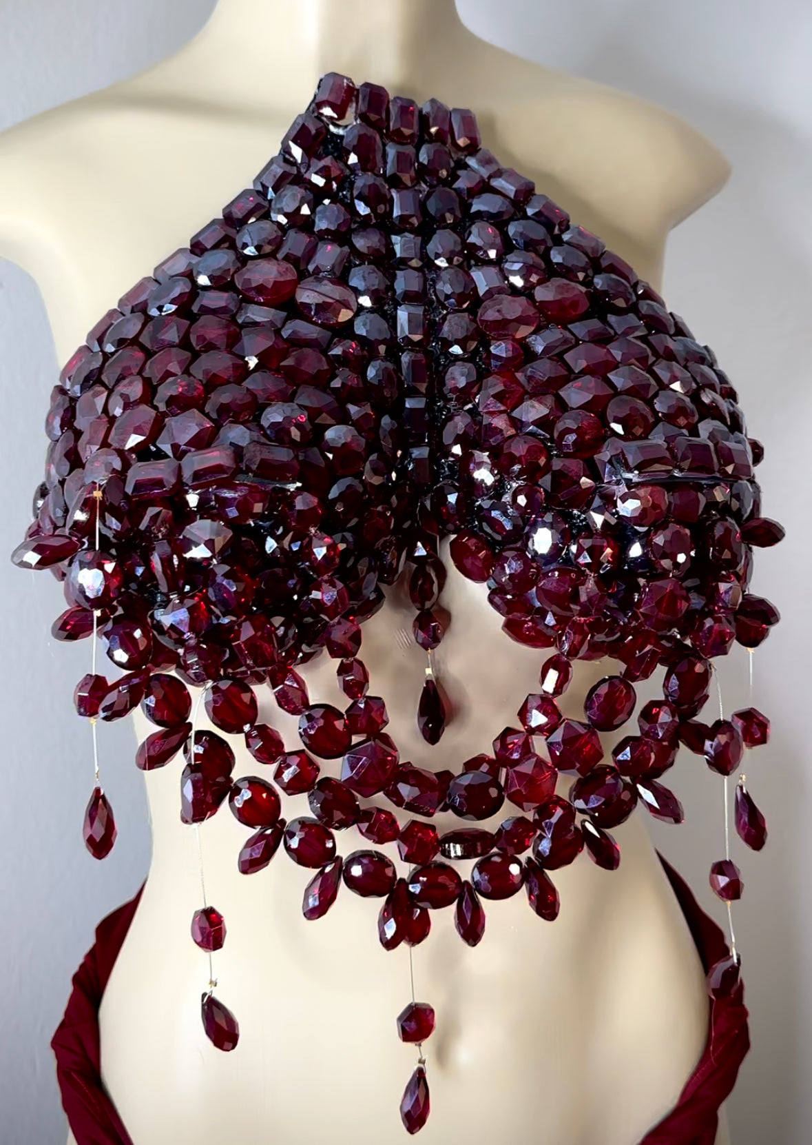 Deep ruby red jeweled breast plate .