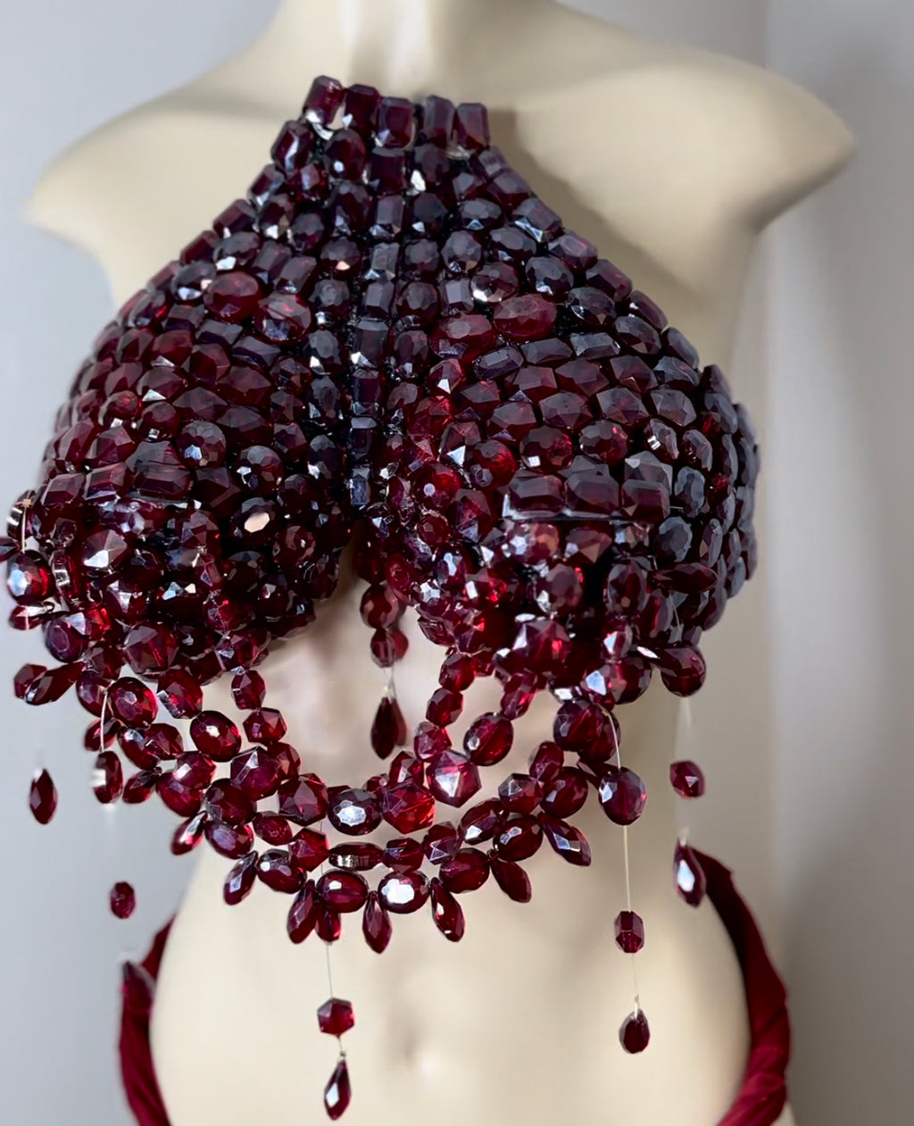 Deep ruby red jeweled breast plate .
