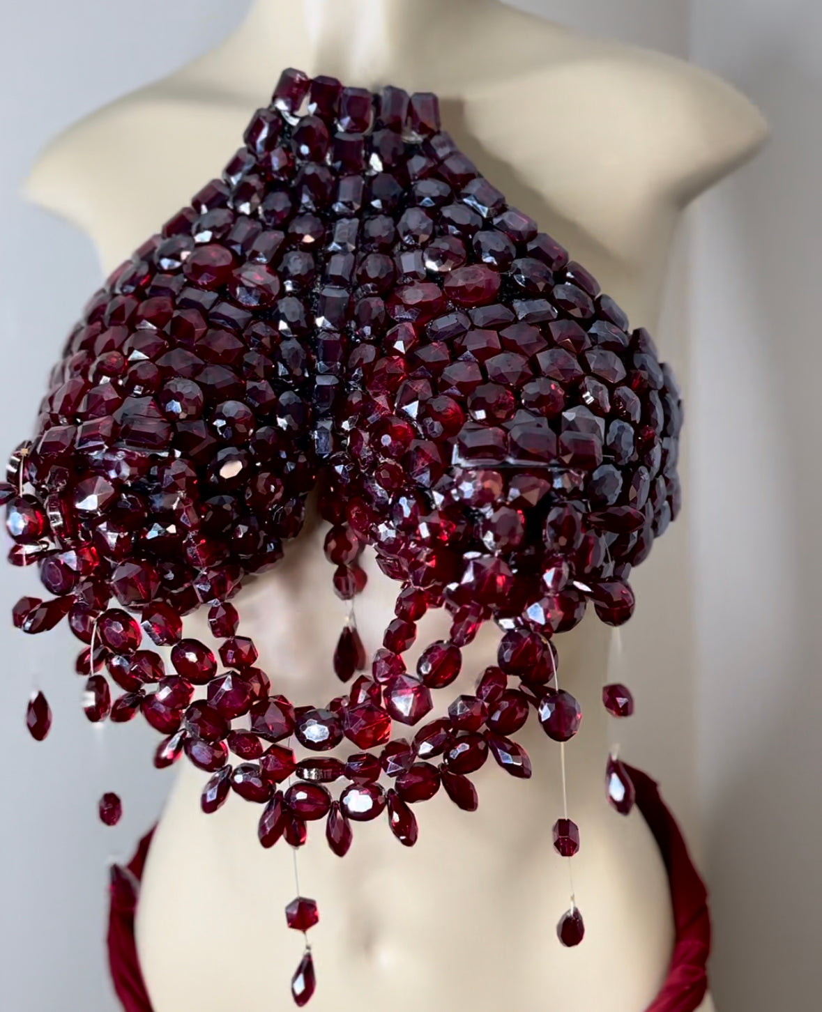 Deep ruby red jeweled breast plate .